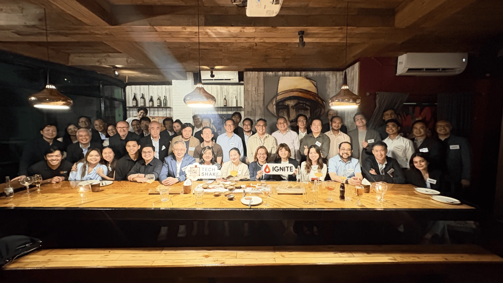 Guests seated at a long table for a TechShake Innovators' Dinner