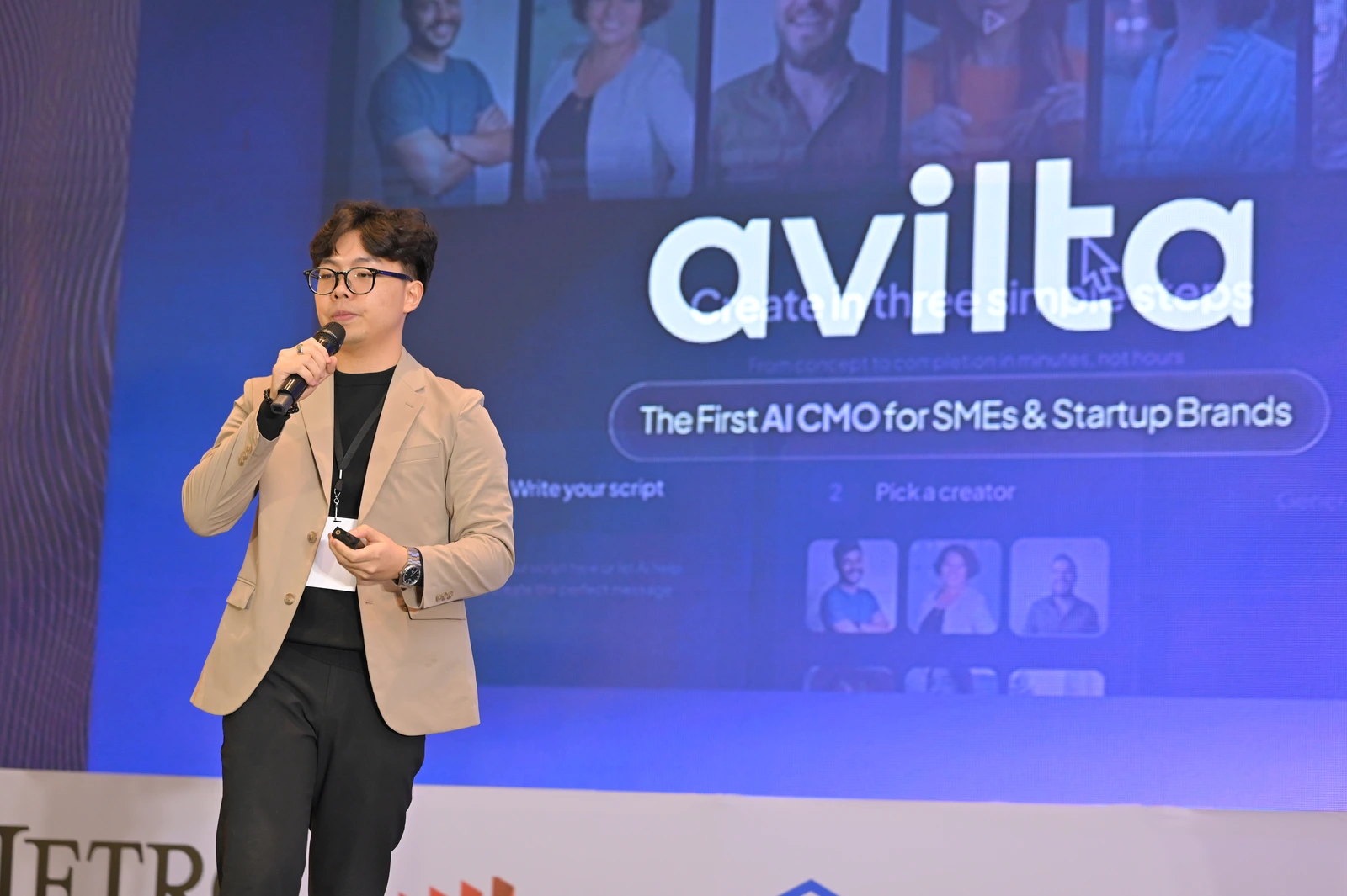 Founder pitching on stage in front of a product slide at IGNITE