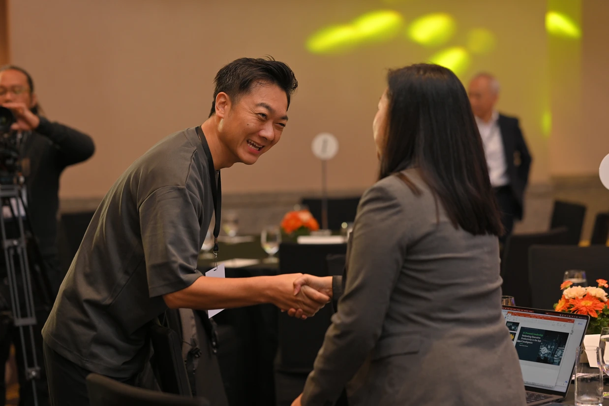 Two attendees greeting each other at IGNITE