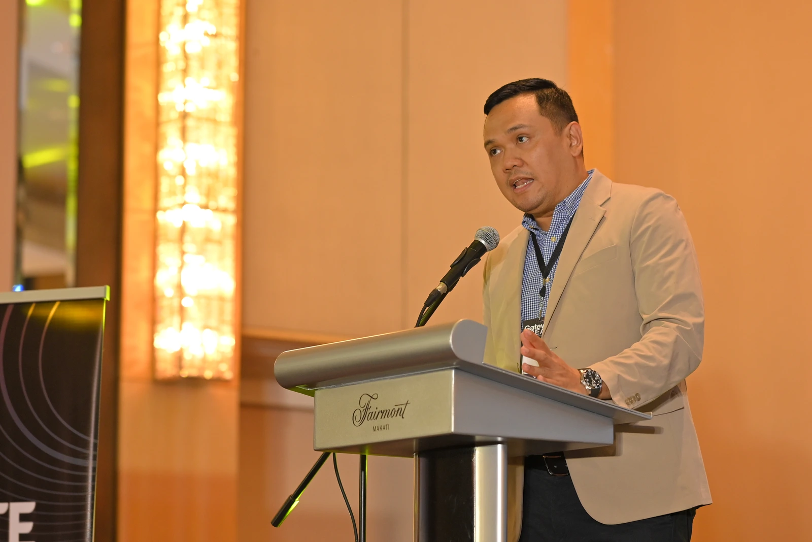 Speaker addressing the audience from the podium at IGNITE