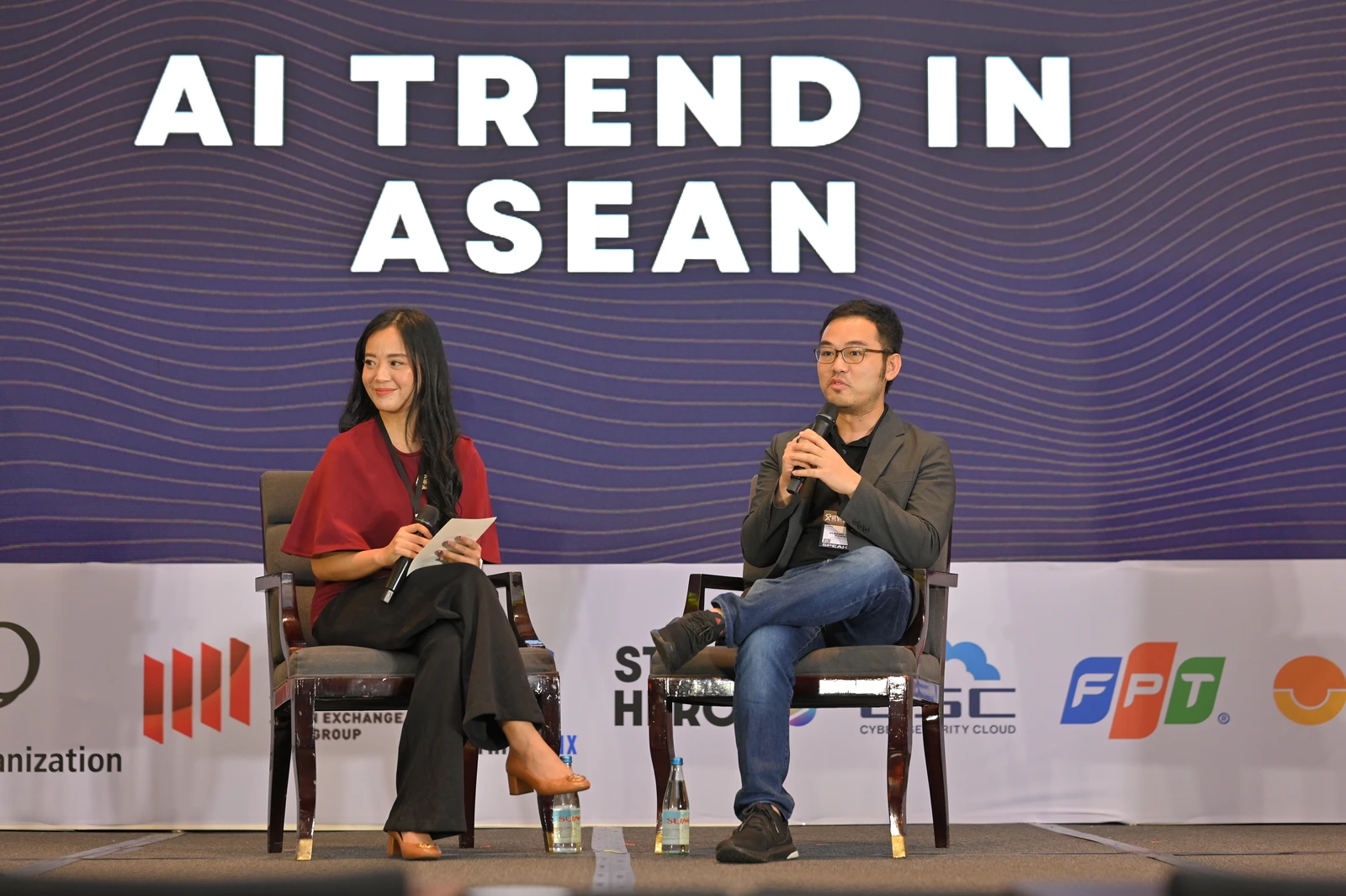 Two speakers on stage during the AI Trend in ASEAN session